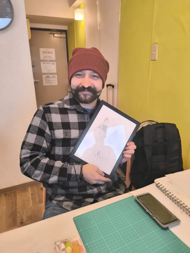 Guest smiling with his framed manga page