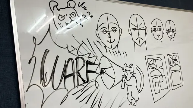 Playful manga character sketch drawn on the studio whiteboard