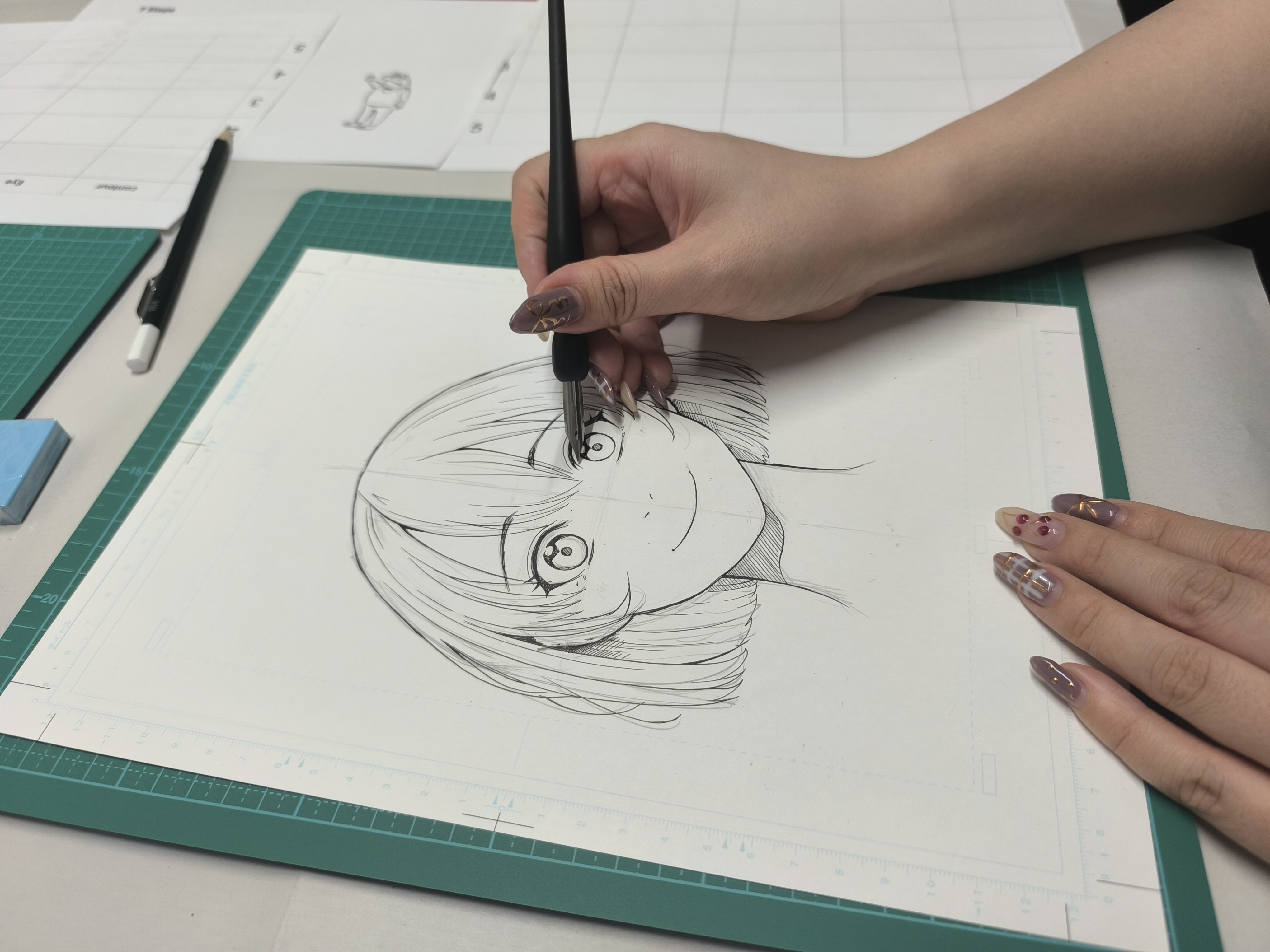 Close-up of hands drawing manga character