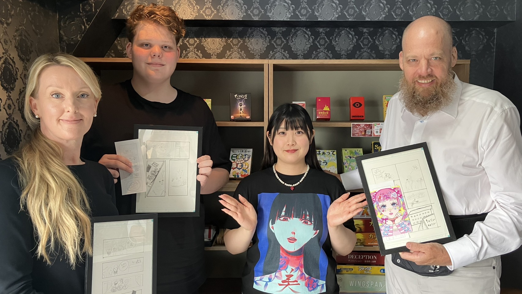 Guests proudly holding their framed manga artwork