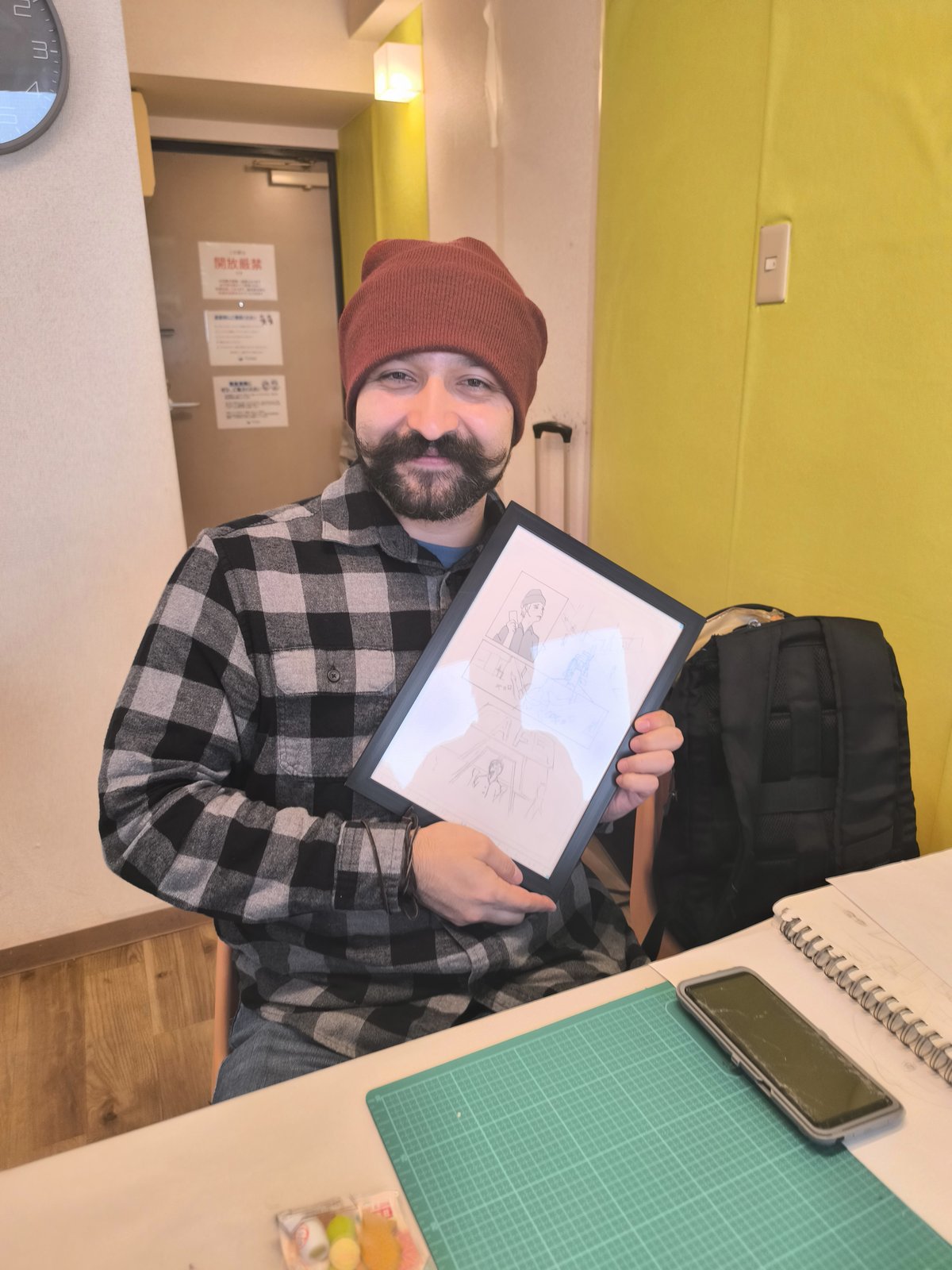 Guest smiling with his framed manga page
